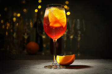 Composition with aperol spritz cocktail and blurred lights. Summer drink