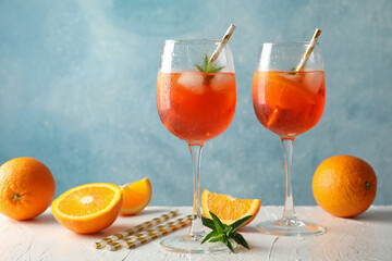 Composition with aperol spritz cocktail against blue background