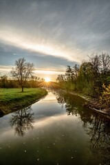 A sunrise over the river during springtime