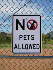 No pets allowed sign on a fence.