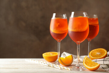 Composition with aperol spritz cocktail against brown background. Summer cocktail