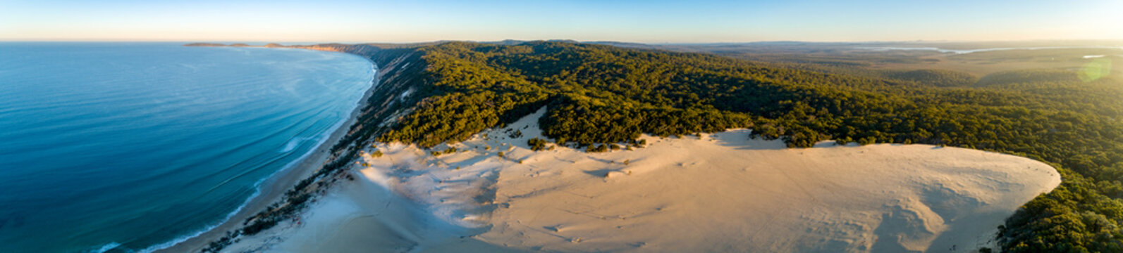 Sunset over Carlo Sandblow and Double Island Point at Rainbow Beach.