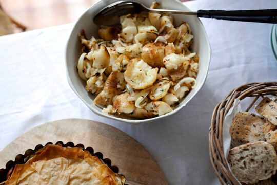 Potatoes, pie and bread rolls on table