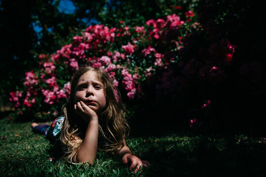 Portrait of girl laying on grass in garden