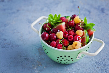 strainer full of summer fruits