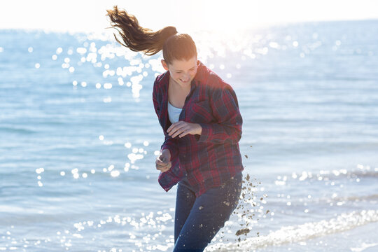 Teenage girl in sand fight on beach