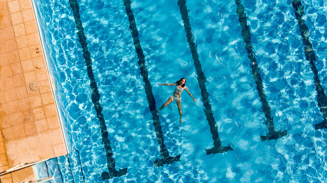 Girl floating in swimming pool