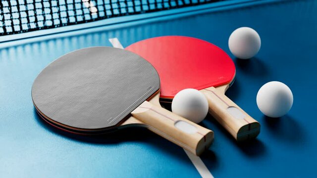 The camera is tilting up the table tennis set. Ping pong balls, paddles and net.