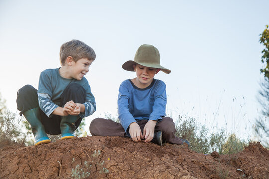 Two happy Aussie kids playing outdoors in natural setting