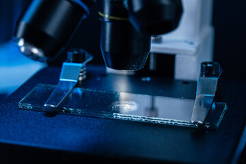 Microscope with lenses close up against dark background