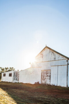 Sun flare over showground pavilion shed in rural country town