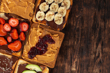 Assortment of sweet sandwiches with chocolate paste, peanut paste and fruit slices