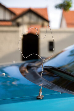 Foto Stock A car antenna made out of a coat hanger and shaped like a map of  Australia | Adobe Stock