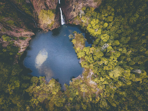Drone photo of waterfall and swimming hole surrounded by outback bushland