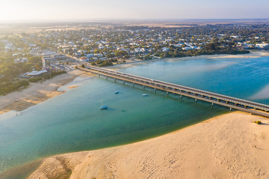 Aerial view of bridges across a river mouth around a coastal town