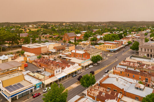 Aerial view of a regional town center under a dust cloud