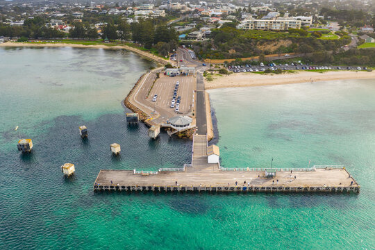 Looking down on a ferry terminal and jetty off a coastal town