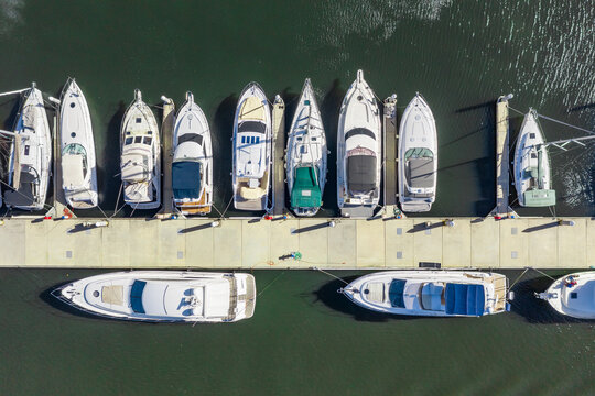 Aerial view of expensive yachts lined up at a jetty