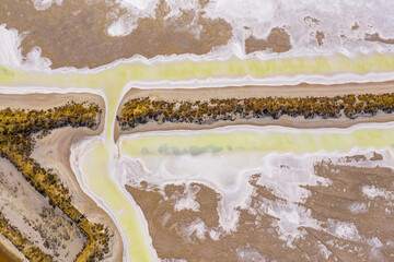 Aerial view of a creek joining two salt evaporation ponds
