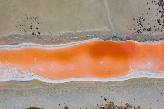 Aerial view of multi-colored salt pans at a commercial saltworks