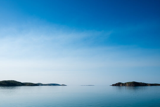 Islands in the distance through glassed off water in remote location