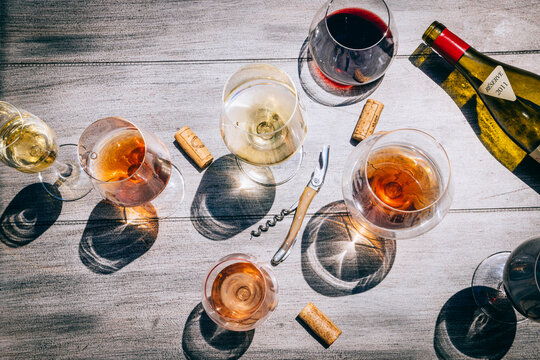 Close-up abstract images of wine glasses filled with red, white and rose wine on table - Powered by Adobe