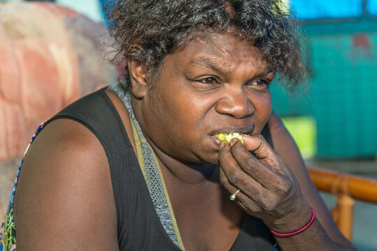 Aboriginal female eating Kakadu Plum