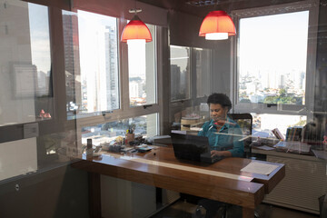 afro brazilian business woman alone in the modern office