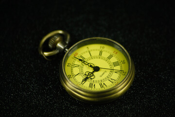 vintage classic women's pocket watch on a black background, isolated from the background. soft fokus.