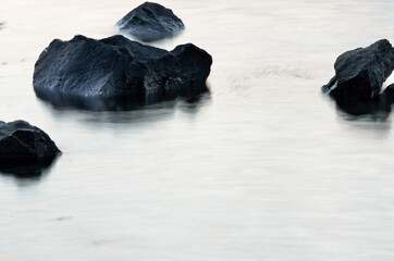Fototapeta na wymiar Beautiful stones in misty arctic circle fjord water