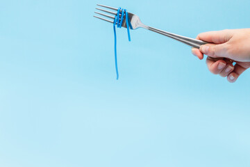 wires wound around a fork on a blue background