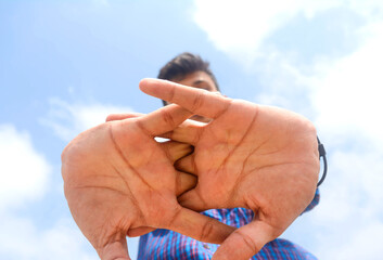 Portrait of attractive hand movements of teen student on sky background.