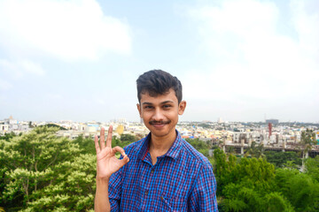 Young stylish man pointing on copy space.attractive hand movements of man.handsome young teen.