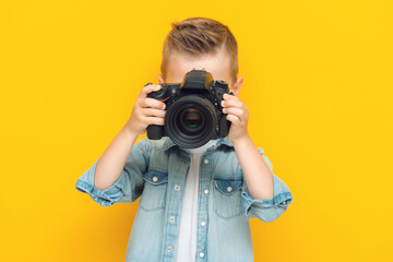 Adorable little kid taking a photo using a digital camera - Powered by Adobe