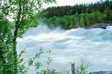 fast flowing rapid river with waterfall