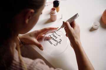 Creative woman making handmade Christmas ornament