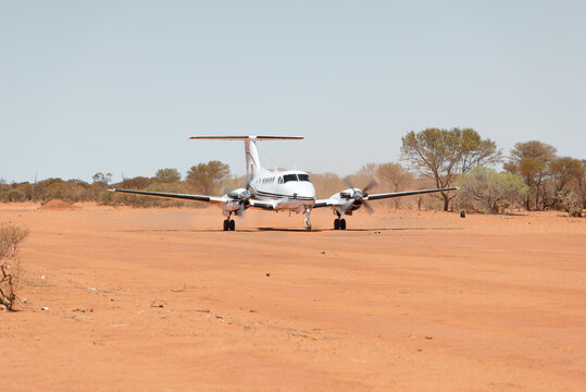 Small charter plane landing at remote air strip