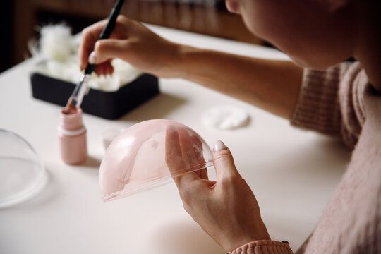 Positive woman creating handmade Christmas decoration