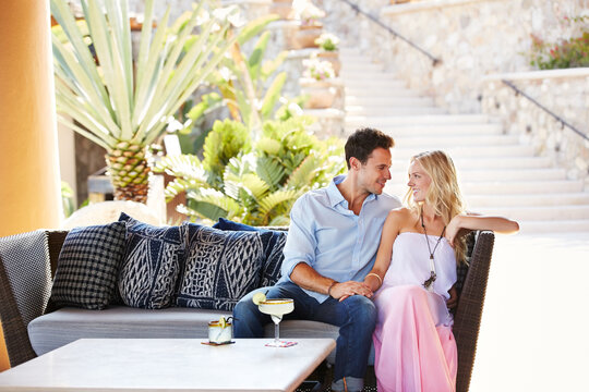 Couple drinking cocktails at a resort in Mexico - Powered by Adobe