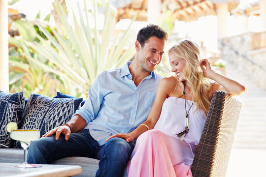 Couple drinking cocktails at a resort in Mexico - Powered by Adobe