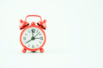 red alarm clock on a turquoise background