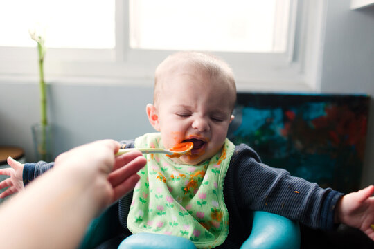 baby eating baby food off spoon