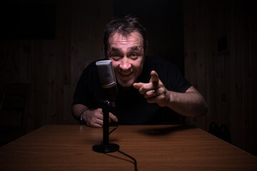 Serious reporter in television studio looking at the camera