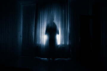 Horror woman in window wood hand hold cage scary scene halloween concept Blurred silhouette of...