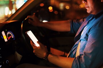 man using smart phone in car.