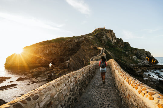 woman walking forward to the chapel in Gaztelugatxe island
