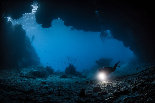 Silhouetted Diver in a Cave