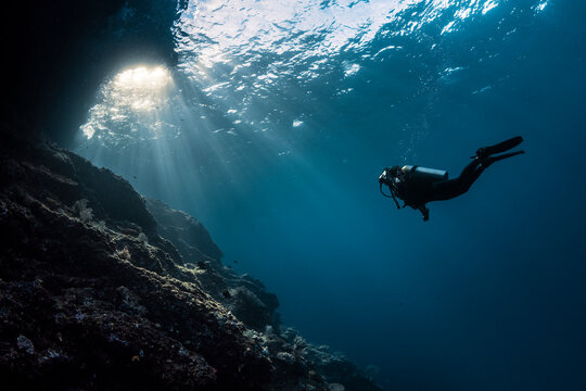 Scuba Girl Swimming into Sunlight