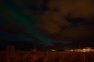 Naklejka na ściany i meble beautiful aurora borealis on the arctic night sky in late autumn