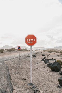 Road sign in mountains with rejection stop eating animals.